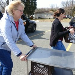 Members of the Community Response Team and other volunteers work to quickly set up a school food pantry.