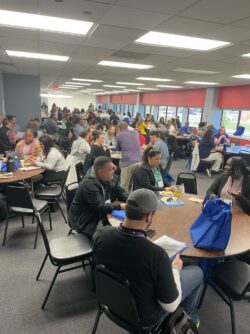 attendees sit at tables in a full room at the IL state coalition meeting