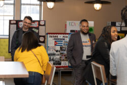 folks conversing at student displays during awards